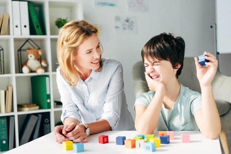 child with autism playing with therapist